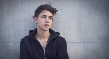 Yakışıklı genç adam gri duvar ayakta