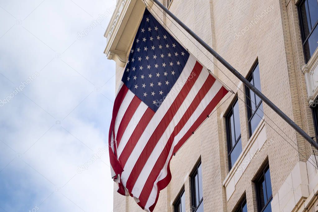 US flag displayed from traditional Los Angeles downtown city building.