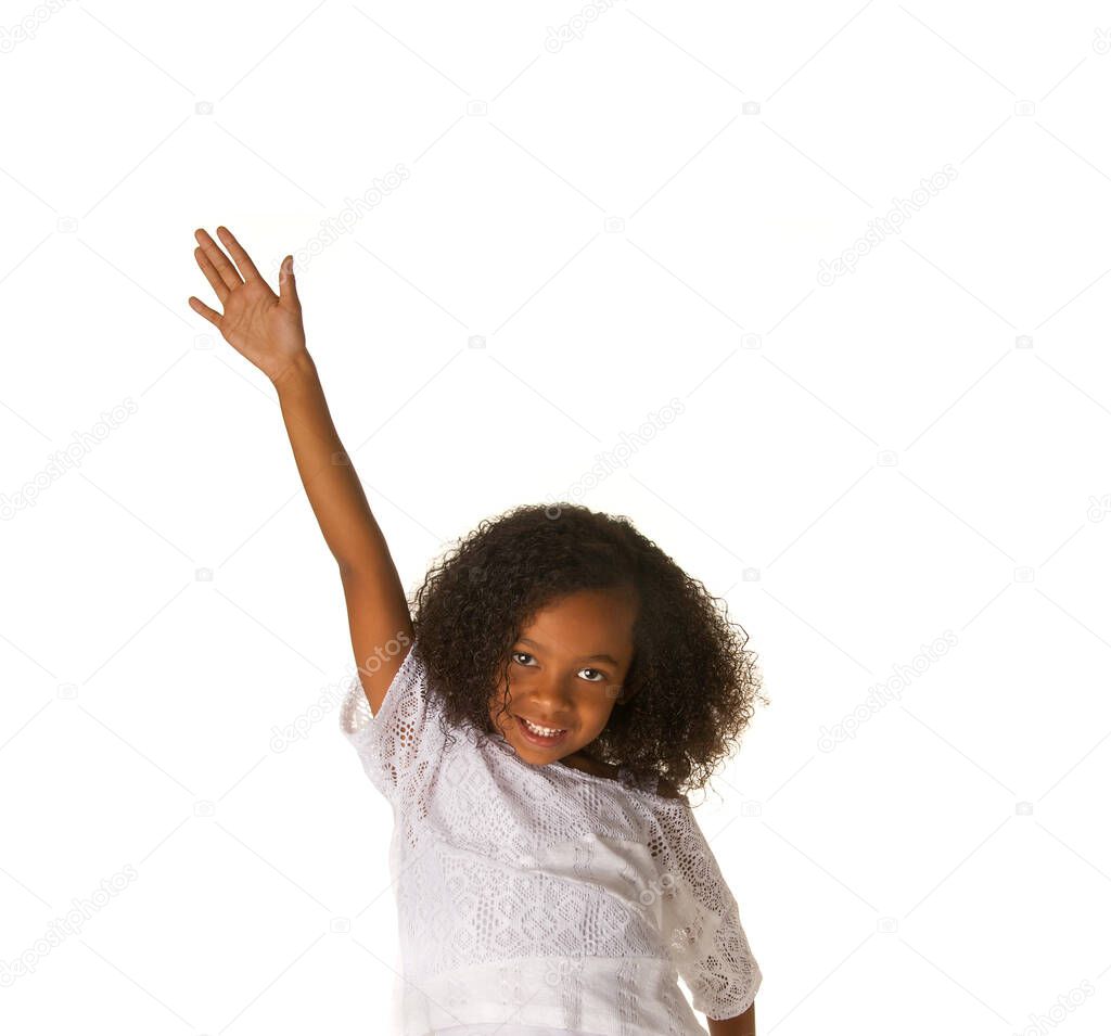 Smiling child with hand raised to ask question.