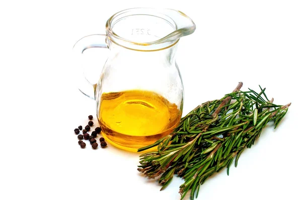 Olive oil in a jug and a branch of rosemary isolated on white — Stock Photo, Image