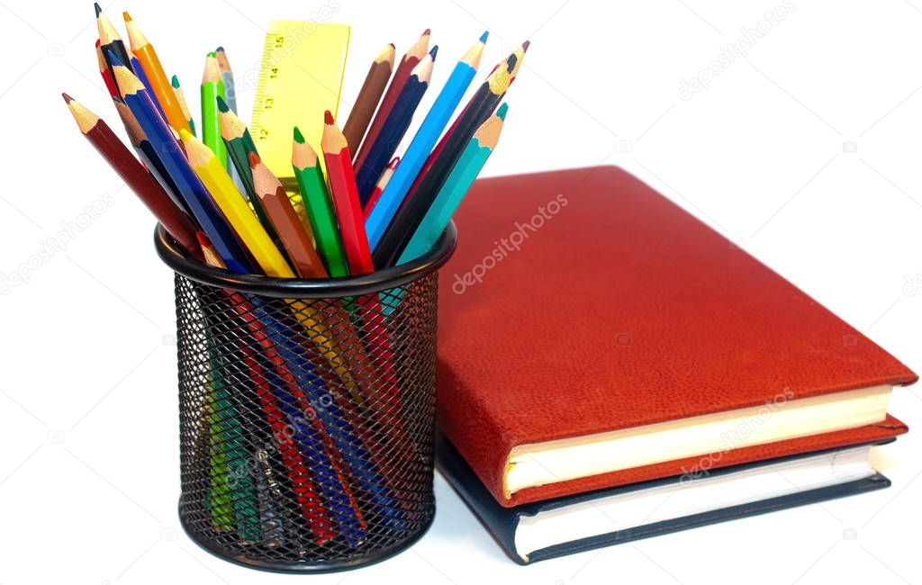 Color pencils and books isolated on white