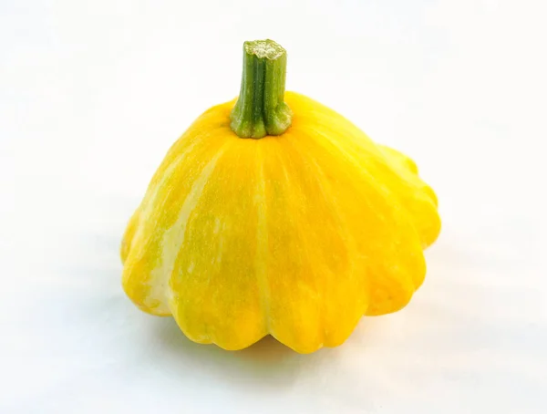 Young gentle yellow bush pumpkin on a light neutral background