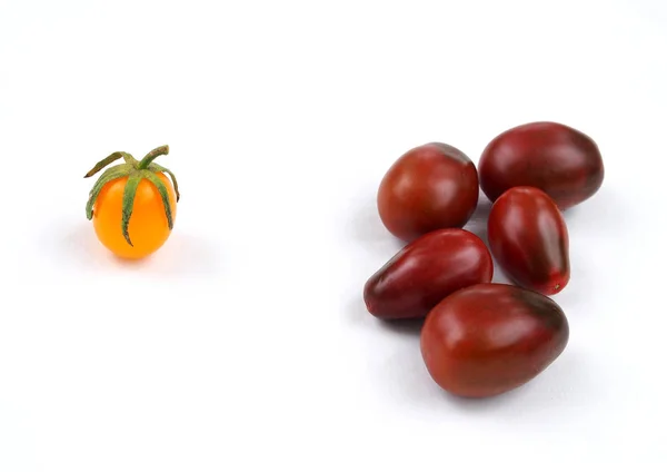 Mehrere Dunkelrote Tomaten Und Eine Gelbe Tomate Auf Weißem Hintergrund — Stockfoto