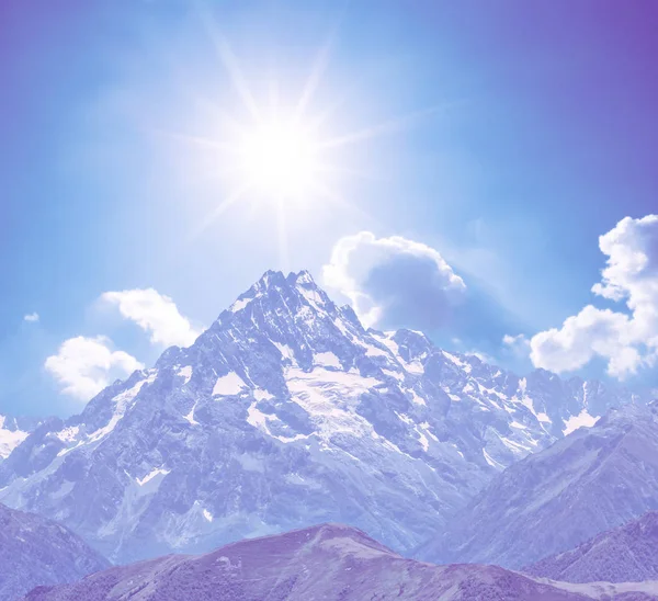 mount top in a snow under a sparkle sun, natural violer colorised background