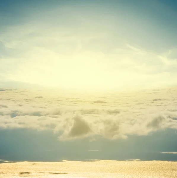 sparkle sun and dense clouds above a sea scape