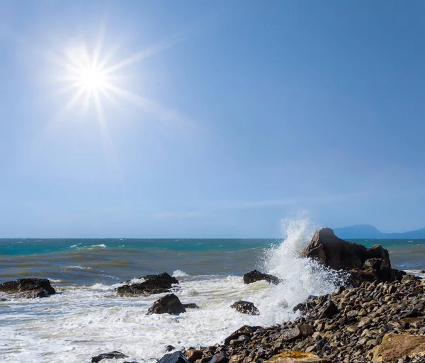 rocku sea coast at the storm under a sparkle sun