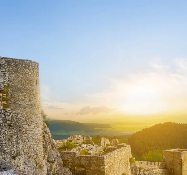 old castle tower on the green hill at the sunset, old medieval ruin museum