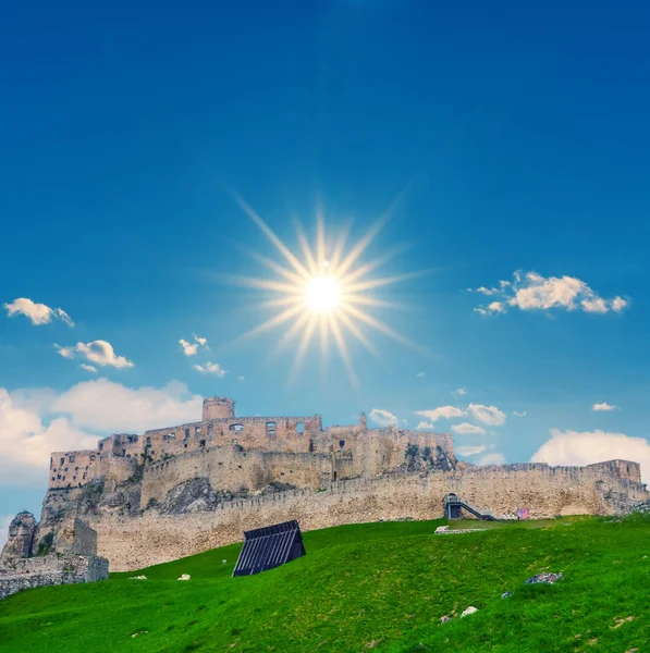 old fortress on the green hill under a sparkle sun, old medieval ruin museum