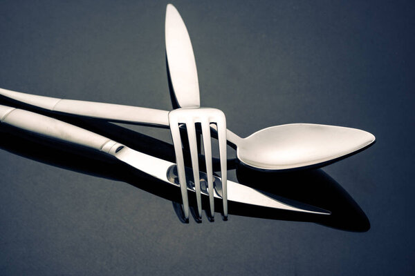 Metal spoon and fork on table