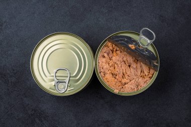 Canned tuna in brine isolated on black background