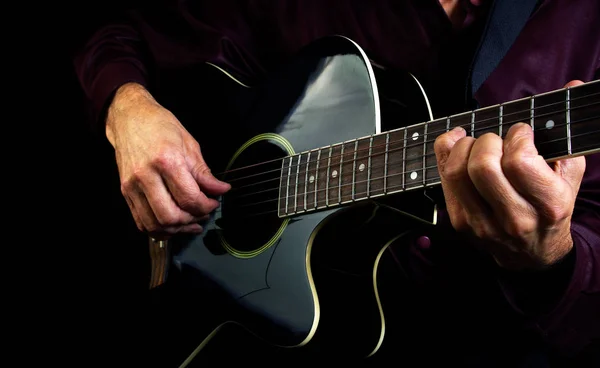 Playing an Acoustic Guitar. Closeup. Guitarist hands and guitar