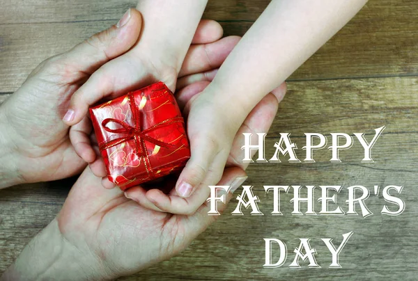 Son gives a gift to dad. Father\'s Day.