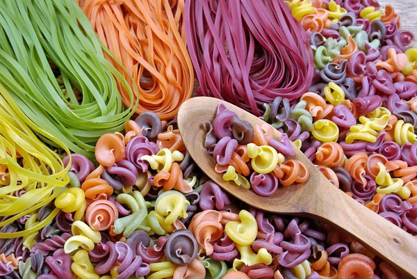 colored pasta on a wooden table.