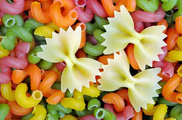 colored pasta texture background. top view