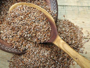 Ham keten bir tahta kaşık yakın çekim içinde tohumları. 