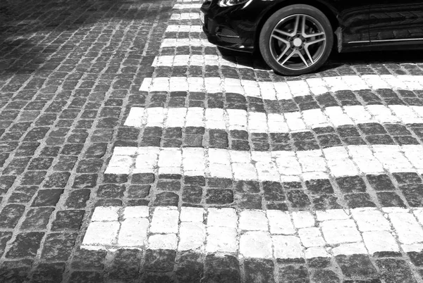 crosswalk. old paved stone road. black and white
