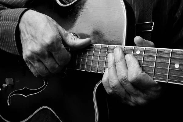 Guitarist hands and guitar close up. playing electric guitar. play the guitar. black and white.