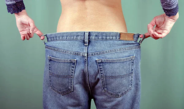 Slim Girl Big Jeans Back View Young Woman Shows Slimmed — Stock Photo, Image