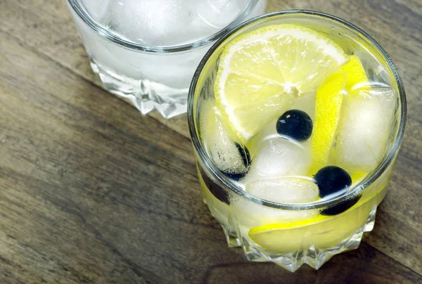 Glas Kaltes Wasser Mit Eis Und Zitrone Auf Einem Holztisch — Stockfoto