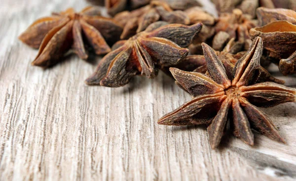 star anise, cinnamon, and roasted coffee beans on a wooden table. roasted coffee and spices. top view. copy spaces.