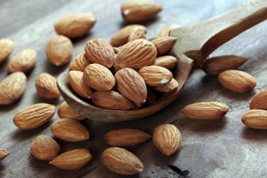 ahşap bir masada bir kepçe badem fıstığı yakın