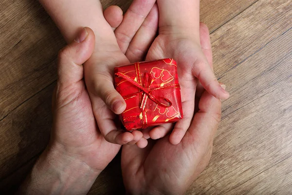 Son gives a gift to dad. Father's Day.