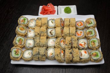 Beyaz bir tabakta suşi rulosu.