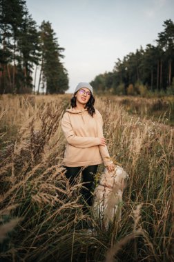 Girl with golden retriever in the field