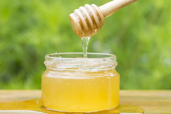 Glass Jar Honey Stick Green Background — Stock Photo, Image