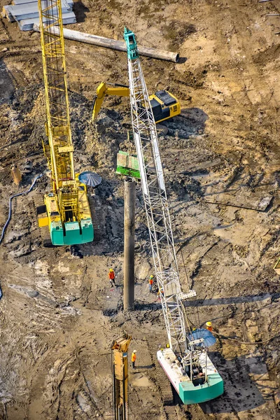 Aerial view of concrete bored pile foundation work on a construction site.