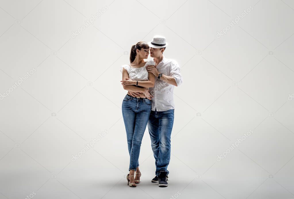 beauty couple dancing social danse ( kizomba or bachata or semba or taraxia) , on light-grey background