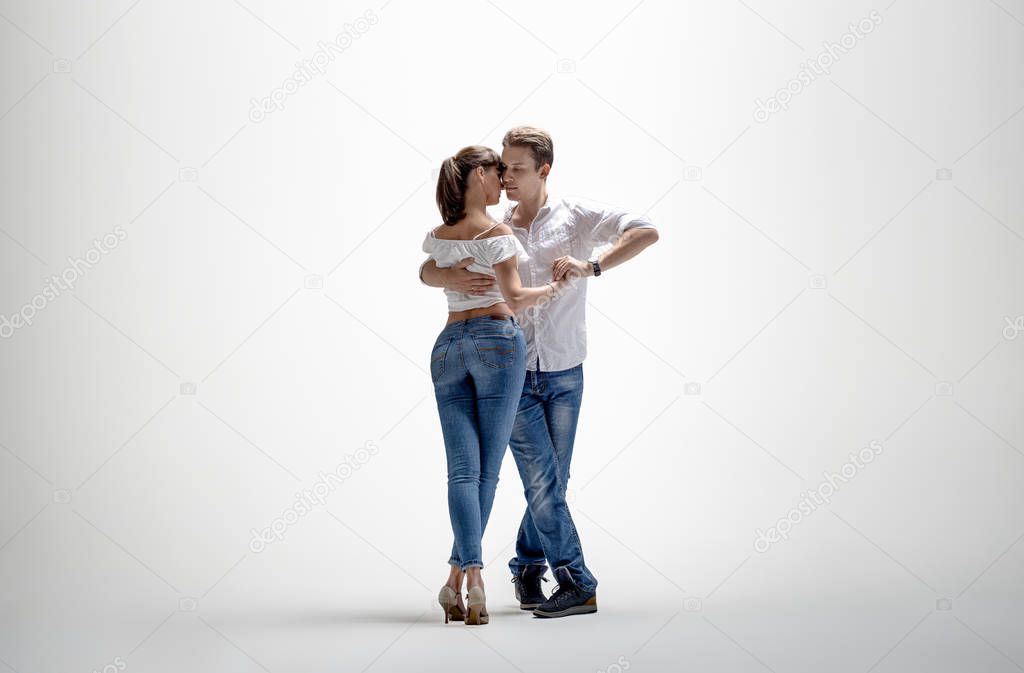 beauty couple dancing social danse ( kizomba or bachata or semba or taraxia) , on light-grey background