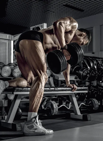 Guy Bodybuilder Perform Exercise Dumbbell Broadest Muscle Back Dark Gym — Stock Photo, Image