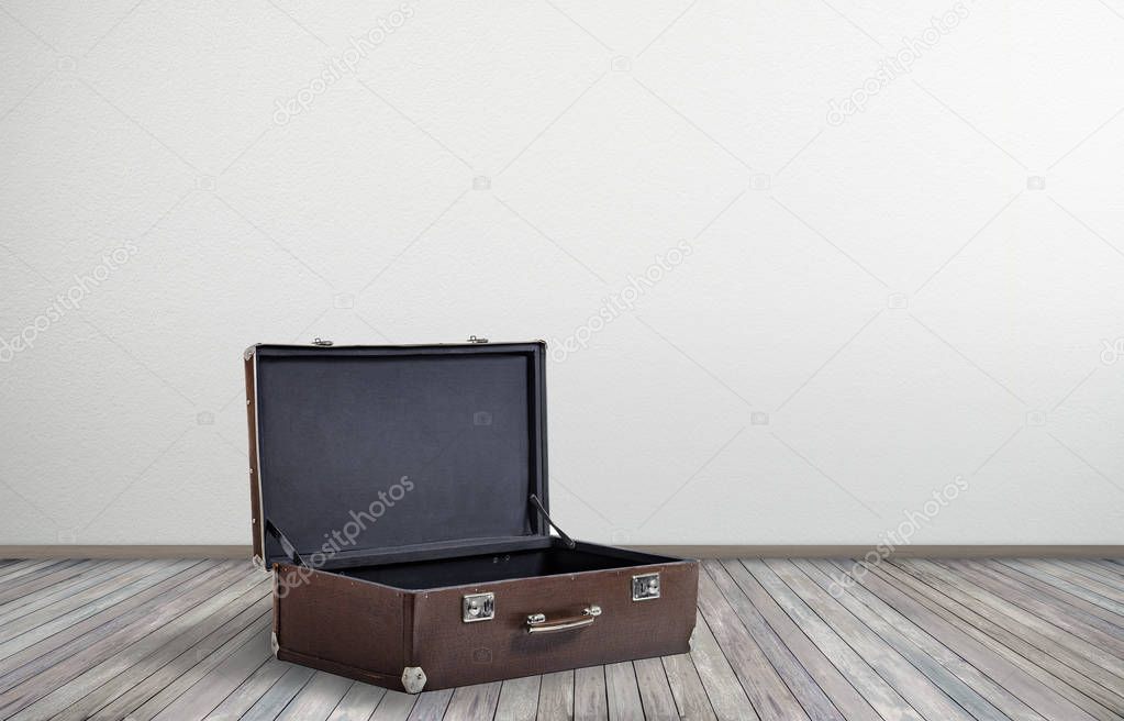 big open vintage empty suitcase in empty room on floor, concept get ready for travel