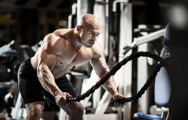 Homem fisiculturista realizar exercício — Fotografia de Stock