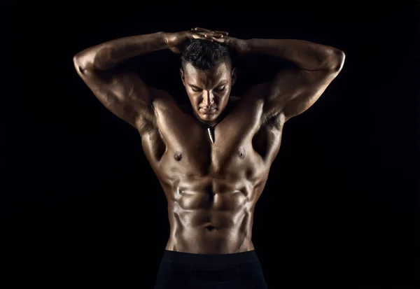 Muscular man on black background — Stock Photo, Image