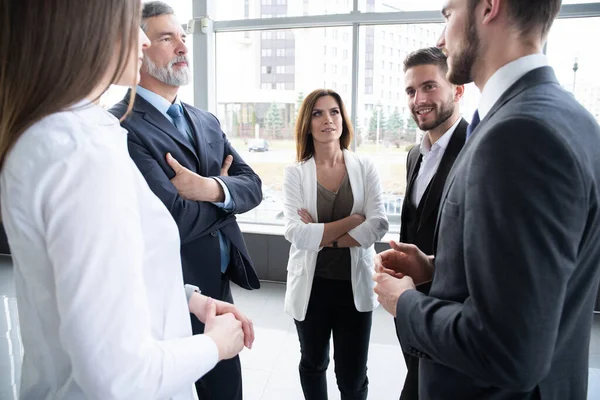 Group of Busy Business People Concept. Business team discussing work in office building hallway. — Stock Photo, Image
