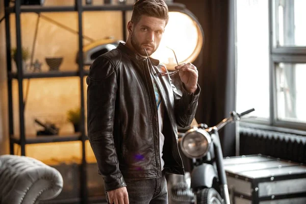 Perfect man. Young hipster in leather jacket standing in room. — Stock Photo, Image
