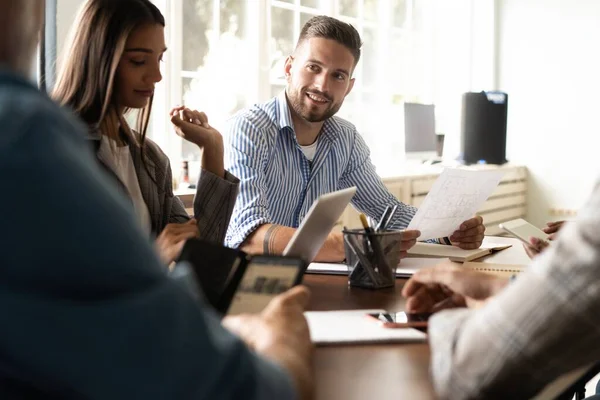 Grupp av unga affärsmän som arbetar och kommunicerar när de sitter vid skrivbordet tillsammans — Stockfoto