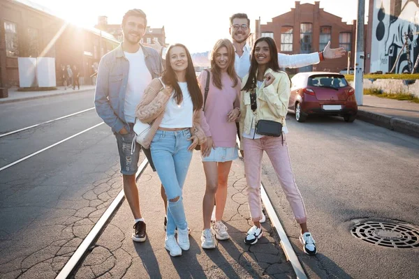 Group of young people having fun together outdoors. City lifestyle and party concept