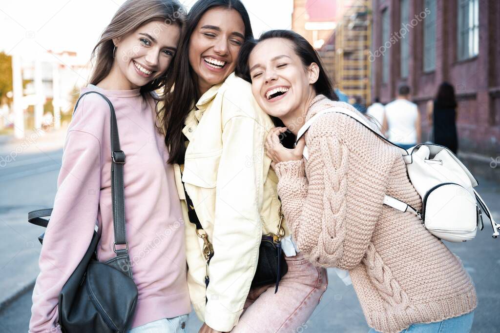Outdoor shot of three young women having fun on city street. Female friends enjoying a day around the city.