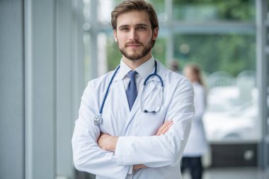 Hastanede mutlu erkek doktor portresi.
