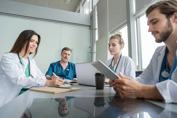 Orvosi csapat megvitatása kezelési lehetőségek a betegekkel. Orvosok csoportja, akik a tárgyalóban tárgyalnak.. — Stock Fotó
