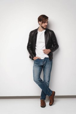 Moda adamı, yakışıklı, ciddi, güzel erkek model portresi deri ceket, beyaz arka planda genç bir adam..