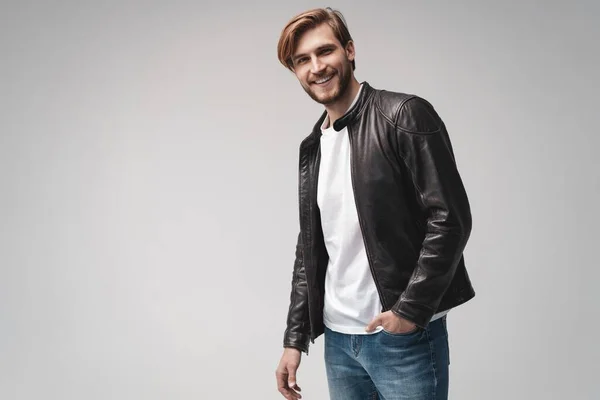 Fashion man, Handsome serious beauty male model portrait wear leather jacket, young guy over white background. — Stock Photo, Image