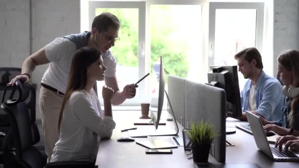 現代オフィスで:管理者や専門家の多様なチームは、コンピュータ上で動作します,同僚と議論を持っています — ストック動画
