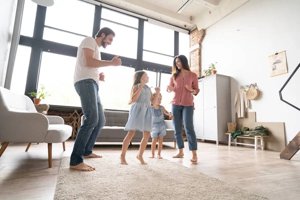 Feliz familia madre padre e hija hija bailando en casa. — Foto de Stock