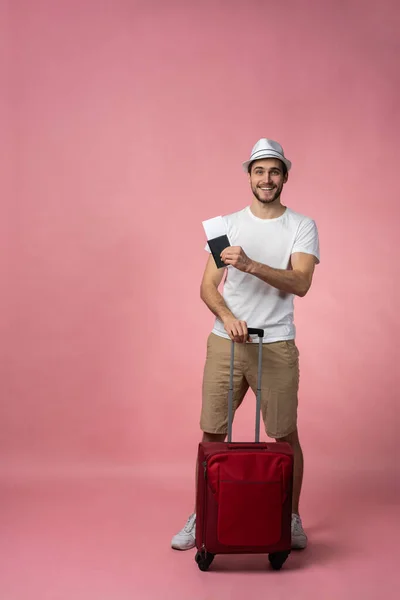 Man traveler with suitcase, passport and ticket on color background. — Stock Photo, Image