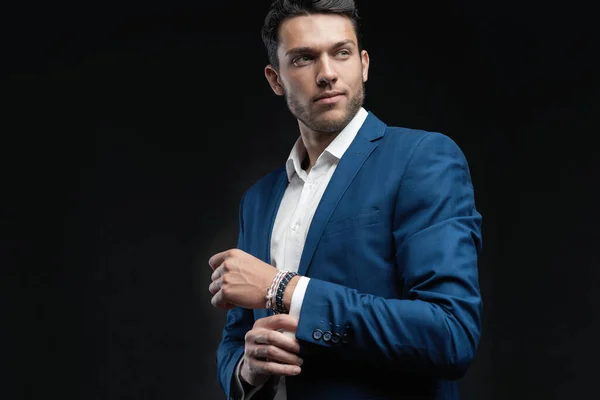 Handsome man wear blue suit isolated on black background. — Stock Photo, Image