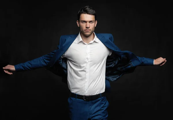 Handsome man wear blue suit isolated on black background. — Stock Photo, Image